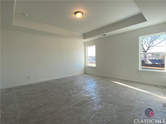 empty room featuring a tray ceiling