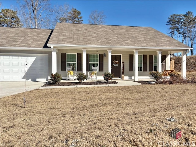 ranch-style house with covered porch, a garage, and a front lawn