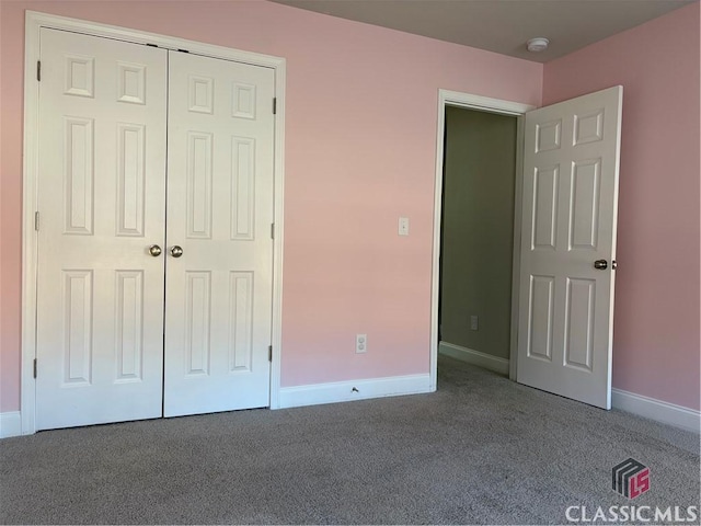 unfurnished bedroom with a closet and carpet flooring