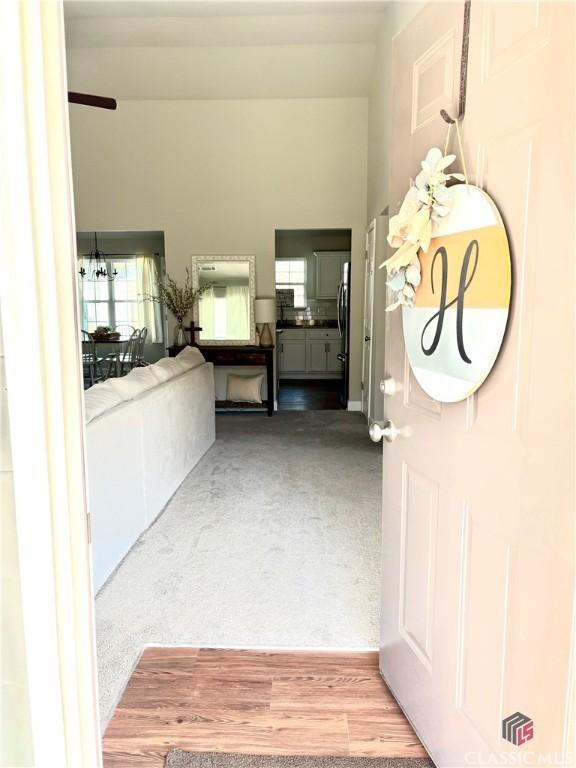 interior space with a notable chandelier and carpet flooring