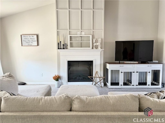 living room featuring lofted ceiling