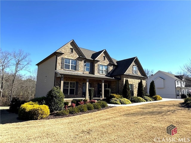 craftsman house with covered porch and a front yard