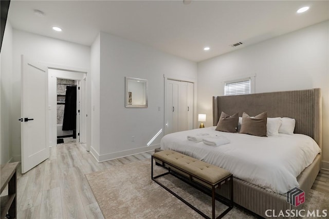 bedroom featuring a closet and light hardwood / wood-style flooring