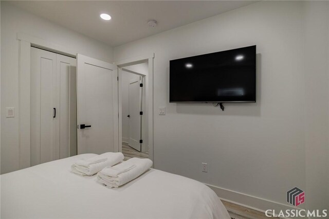 bedroom featuring a closet and light hardwood / wood-style flooring