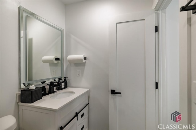 bathroom with toilet and vanity