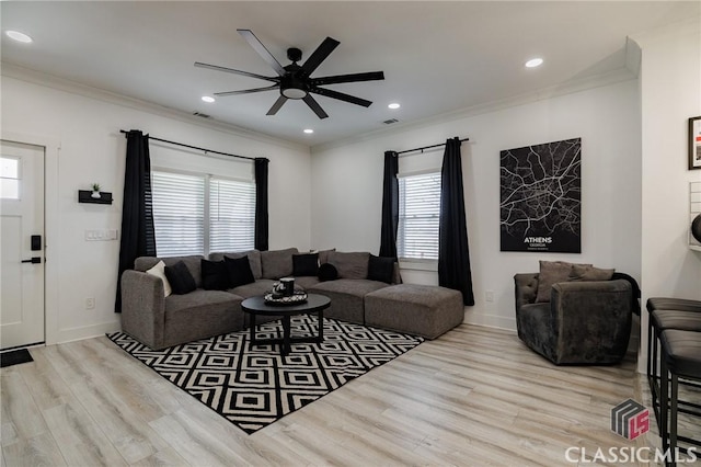 living room with ceiling fan, light wood-type flooring, plenty of natural light, and crown molding