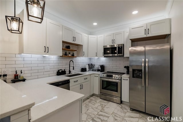 kitchen featuring hanging light fixtures, appliances with stainless steel finishes, sink, and white cabinetry