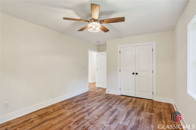 unfurnished bedroom featuring a closet, ceiling fan, and hardwood / wood-style floors