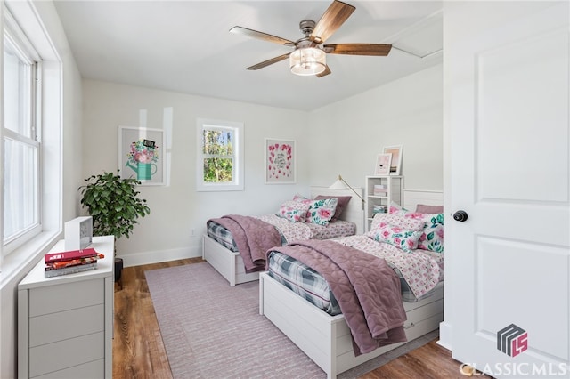 bedroom with dark wood-type flooring and ceiling fan