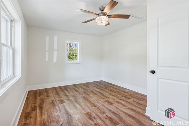 empty room with hardwood / wood-style flooring and ceiling fan