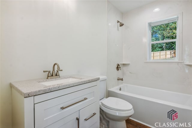 full bathroom featuring toilet, vanity, and shower / washtub combination