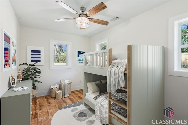 bedroom with wood-type flooring and ceiling fan