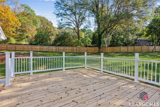 wooden deck featuring a yard