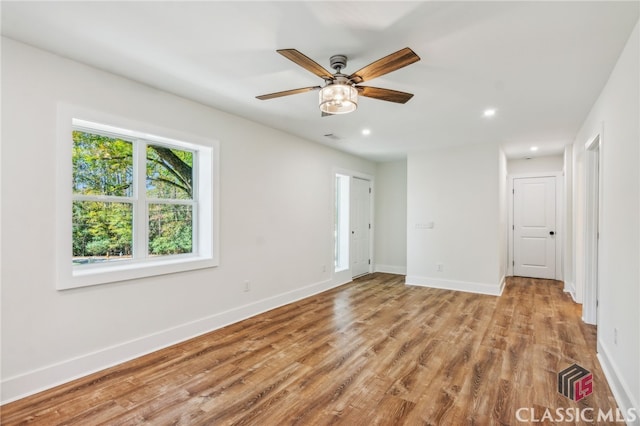 empty room featuring ceiling fan and light wood-type flooring