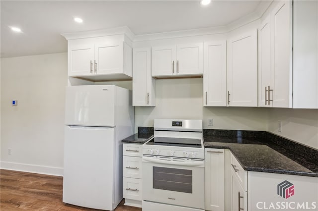 kitchen featuring white appliances, dark stone countertops, white cabinets, and dark hardwood / wood-style flooring