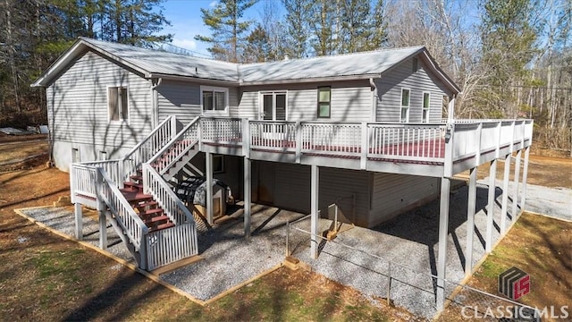 rear view of house featuring a wooden deck