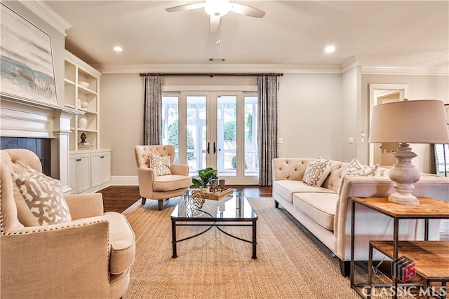 living room with ornamental molding, light wood-type flooring, and french doors