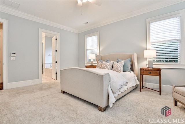 bedroom featuring ceiling fan, ornamental molding, connected bathroom, and light colored carpet