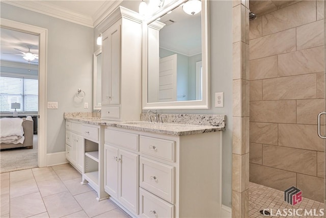 bathroom with tile patterned flooring, ornamental molding, vanity, an enclosed shower, and ceiling fan