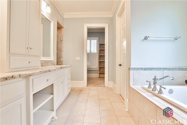 bathroom featuring tile patterned flooring, ornamental molding, a relaxing tiled tub, and vanity