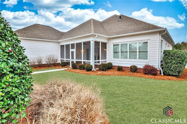 exterior space with a yard and a sunroom