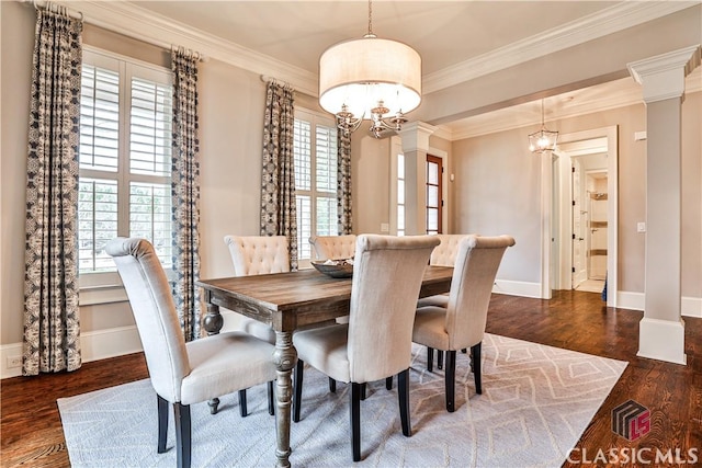 dining area with ornate columns, ornamental molding, plenty of natural light, and dark hardwood / wood-style flooring