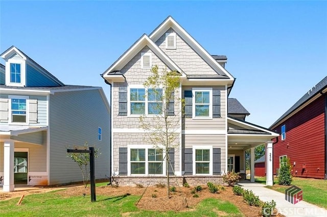 craftsman-style house with a front yard