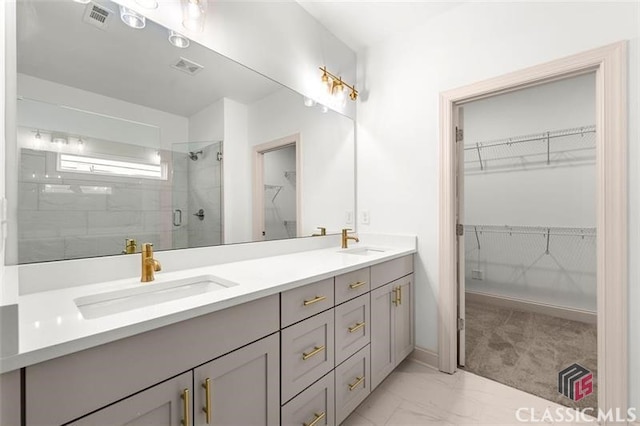 bathroom featuring an enclosed shower and vanity