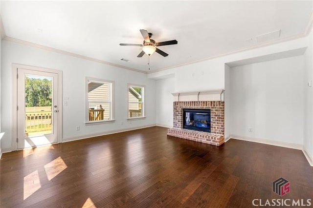 unfurnished living room featuring ceiling fan, dark hardwood / wood-style flooring, crown molding, and a fireplace