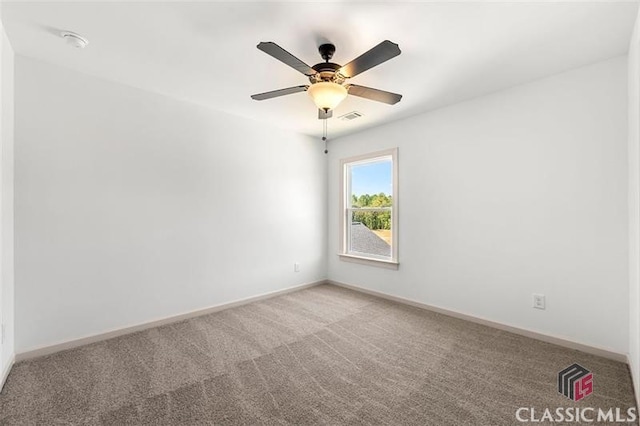 spare room featuring carpet floors and ceiling fan