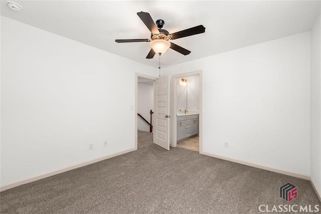 unfurnished bedroom featuring ceiling fan, ensuite bathroom, and light carpet