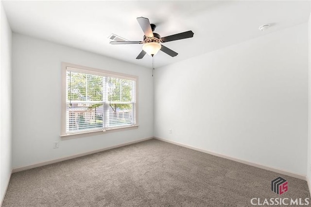 carpeted spare room with ceiling fan