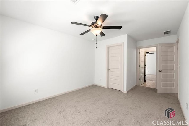 unfurnished bedroom with a closet, ceiling fan, and light colored carpet