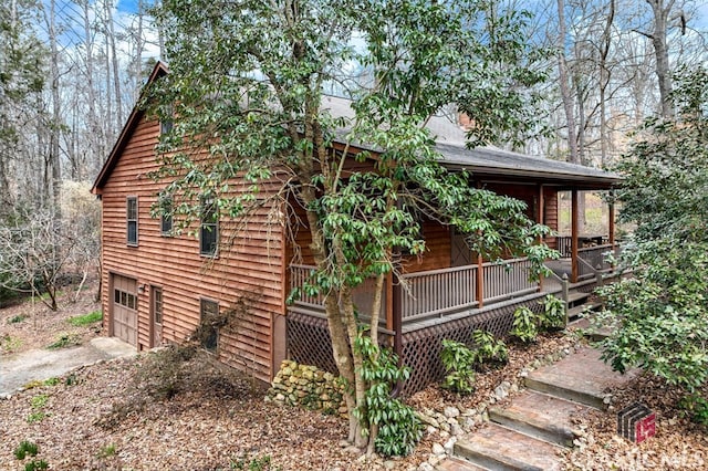 view of home's exterior with covered porch and a garage