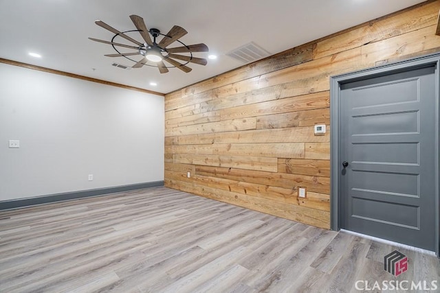 kitchen with stainless steel appliances, sink, light stone counters, and light wood-type flooring