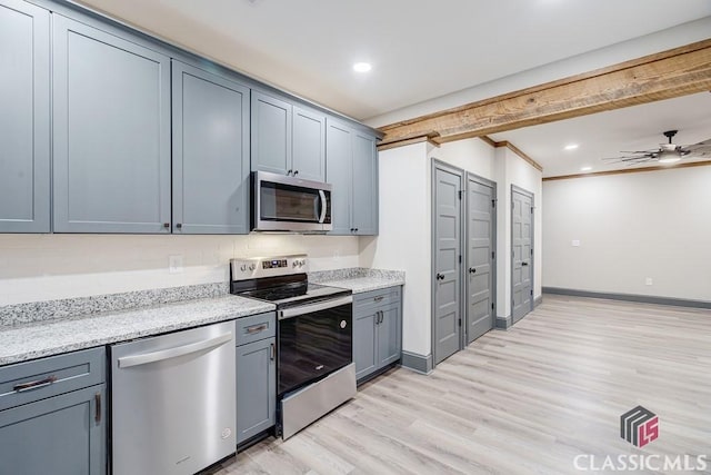 kitchen with gray cabinetry, sink, and tasteful backsplash