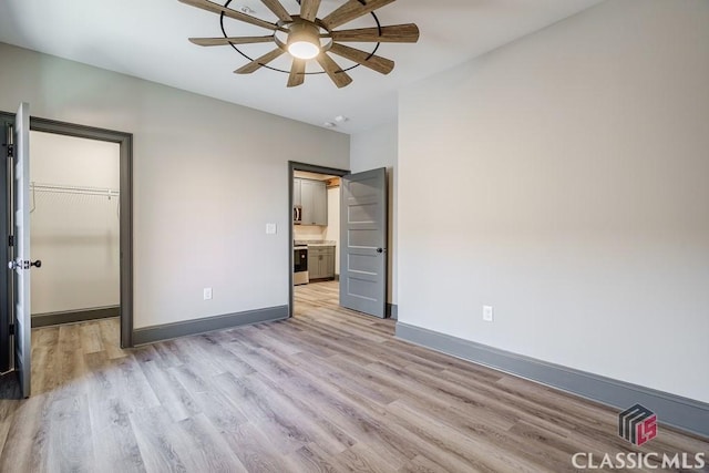 full bathroom featuring vanity, hardwood / wood-style flooring, tiled shower / bath combo, and toilet