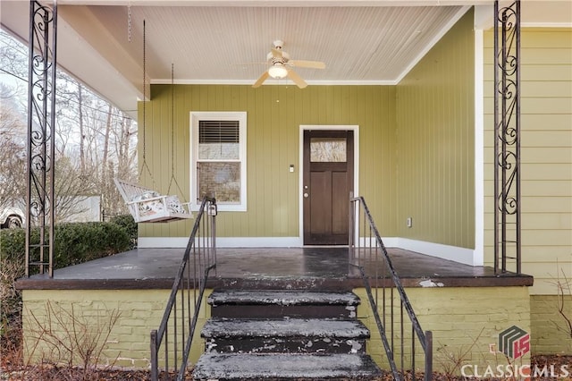 doorway to property featuring ceiling fan and a porch