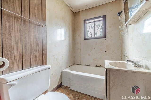 bathroom featuring tile patterned flooring, vanity, a bath, and toilet