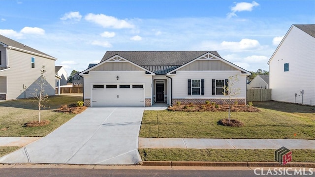 view of front of house with a garage and a front lawn