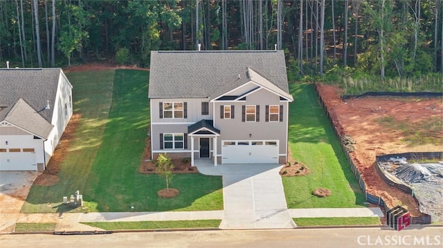 view of property with a garage and a front yard