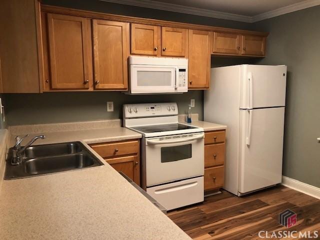 kitchen featuring ornamental molding, sink, dark wood-type flooring, and white appliances