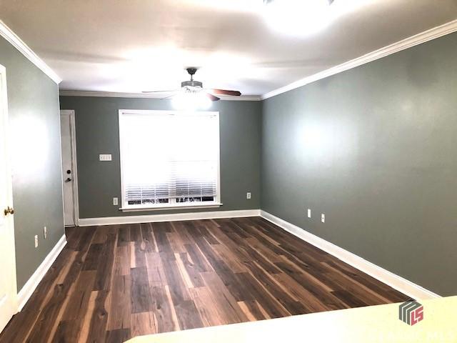 unfurnished room featuring crown molding, ceiling fan, and dark hardwood / wood-style flooring