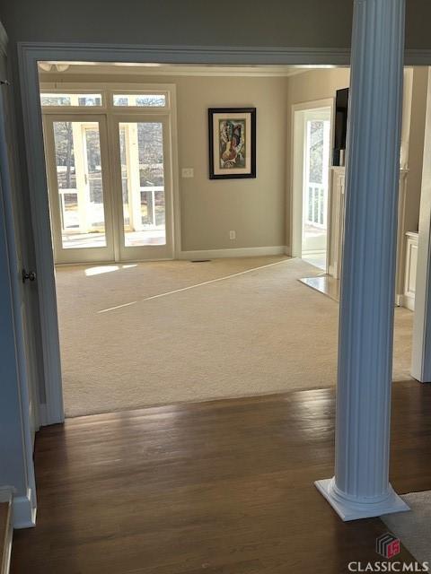 hall with crown molding and dark carpet