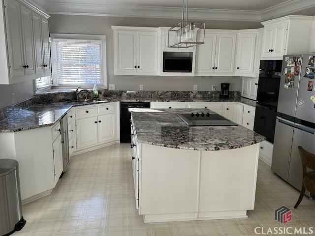 kitchen with sink, decorative light fixtures, a center island, black appliances, and white cabinets