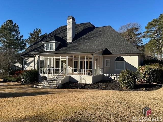 back of property featuring a sunroom