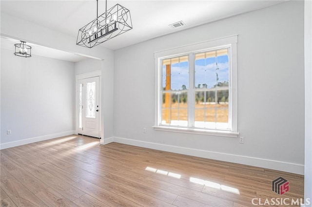 foyer featuring an inviting chandelier and light hardwood / wood-style floors