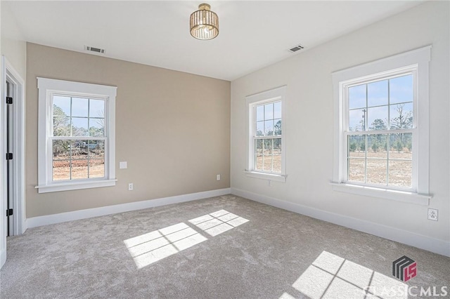 unfurnished room featuring light colored carpet