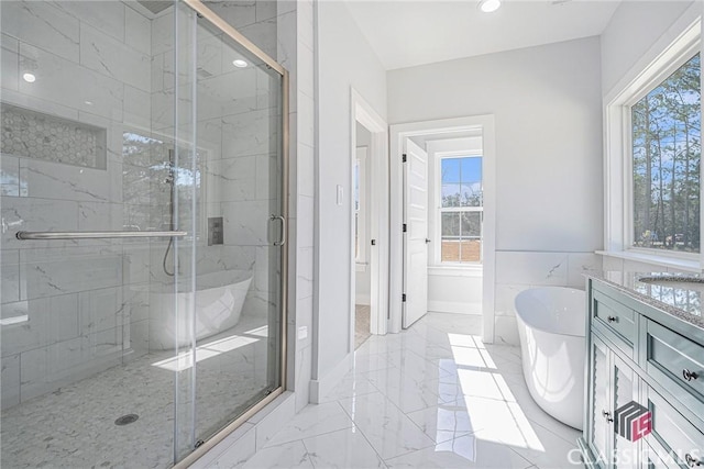 bathroom with vanity, independent shower and bath, and tile walls