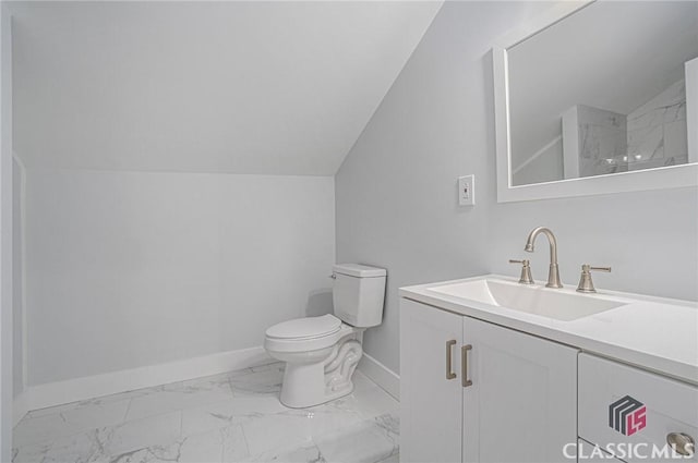 bathroom with lofted ceiling, toilet, and vanity